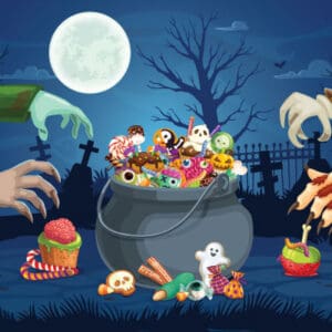 Halloween candy cauldron with spooky hands and treats.