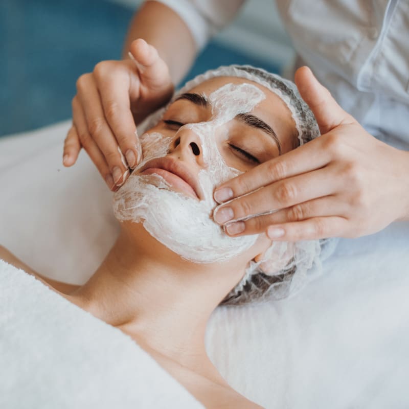 lake-crest-village-facial-services Woman receiving a facial skincare treatment